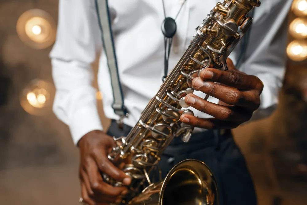 male jazz performer plays the saxophone on stage.jpg